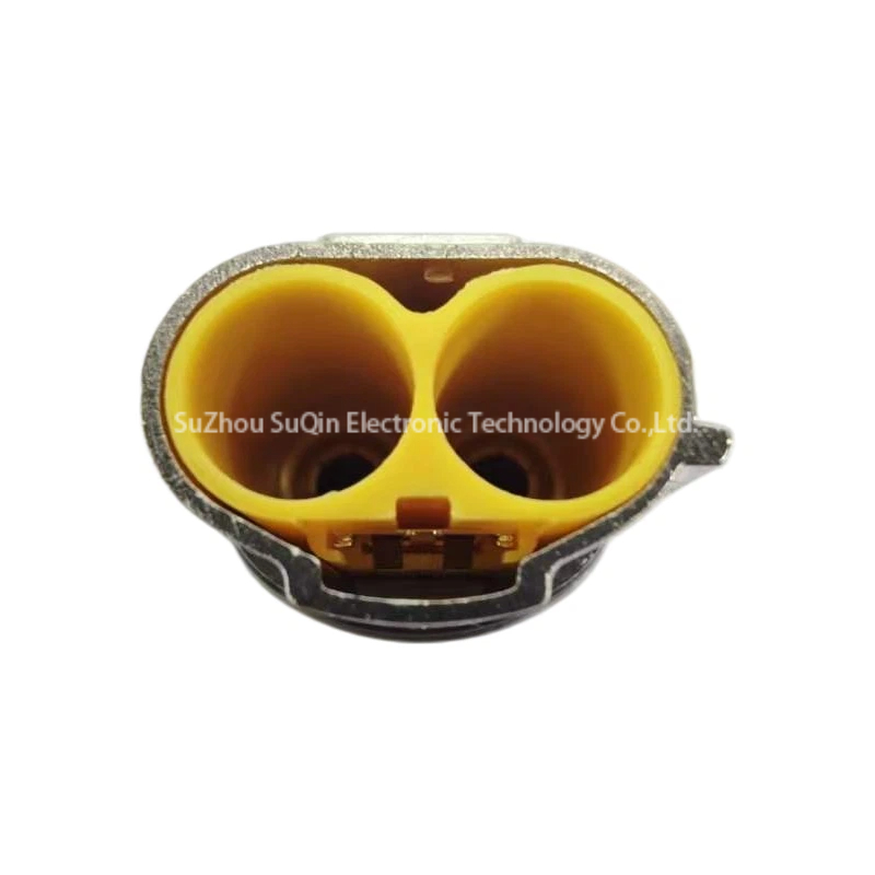Front axial view into the 2-position 4.0mm mating interface of the PL182U-61 plug showing internal yellow insulator cavities and outer metal shielding.