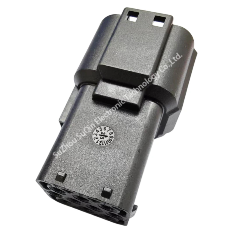 Top angled perspective view of the TSL-FRD10PB black thermoplastic connector housing highlighting the molded circular production date clock stamp on its rigid surface.