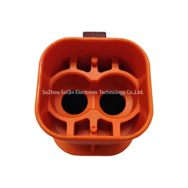 Rear view of the Amphenol HVSL362 orange housing showing the internal terminal chambers designed for 6 AWG power cable insertion.