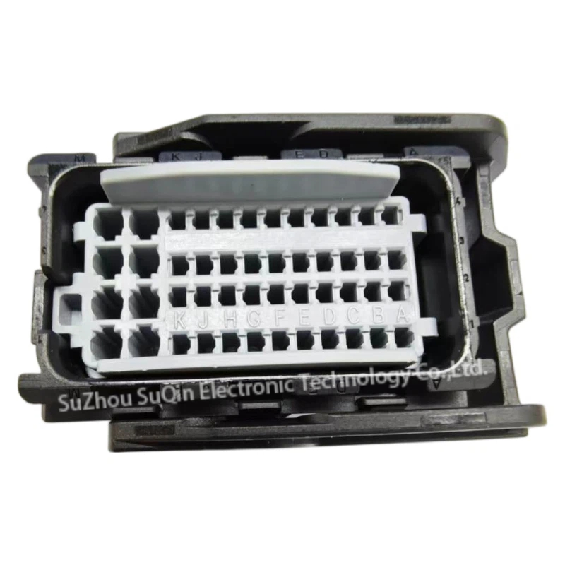 Front mating interface view of the 13956021 connector showing the gray terminal alignment grid plate marked with letter rows and the blue silicone seal