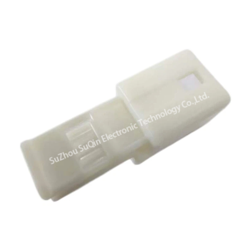Isometric plug view showcasing the sleek white outer housing and terminal insertion guide channel of the NIC02M-W automotive housing.