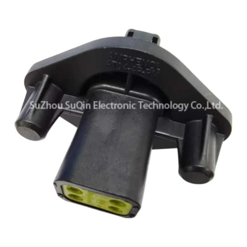 Rear perspective view of an AT04-4P-PM12 rectangular connector housing focusing on the green rear wire entry seal face and molded manufacturer lettering.
