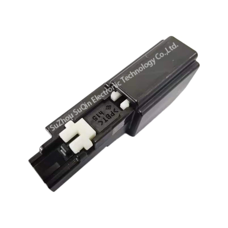 Detail view of Sumitomo 6099-0610 connector housing highlighting the molded resin code >PBT< and pre-inserted white secondary terminal lock.