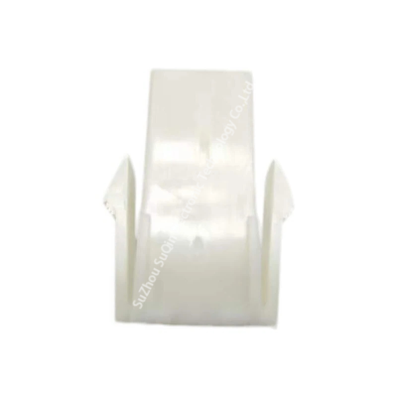 Macro top view of a natural nylon rectangular cap housing highlighting the smooth side rail profile and panel retention geometry.